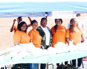 Smiling women at food desk